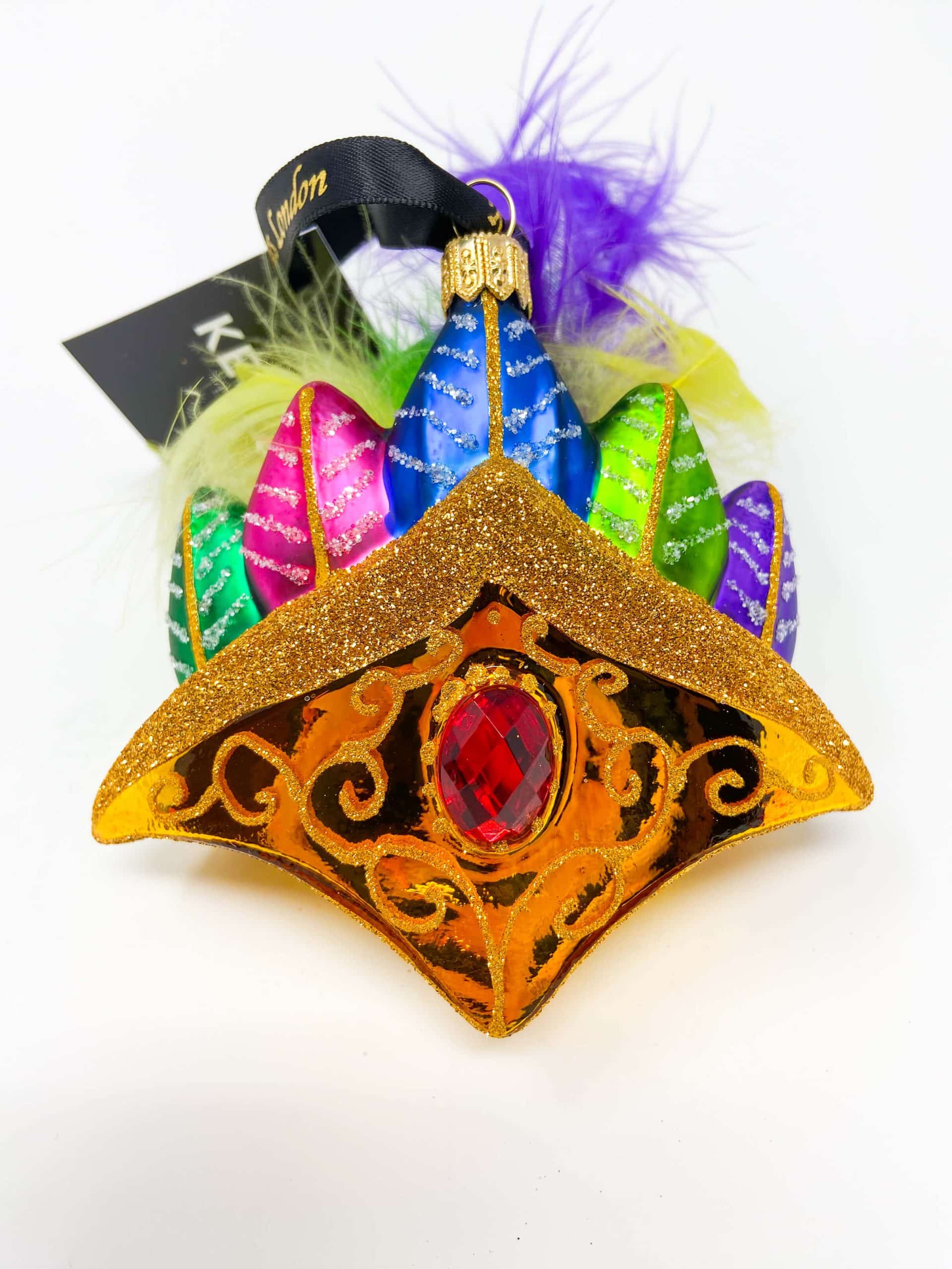 brazilian venetian carnival crown ornament. Fetures gold crown with a large faux gemstone in the center. Surrounded by real and glass feathers in different colors. Saturated colors.