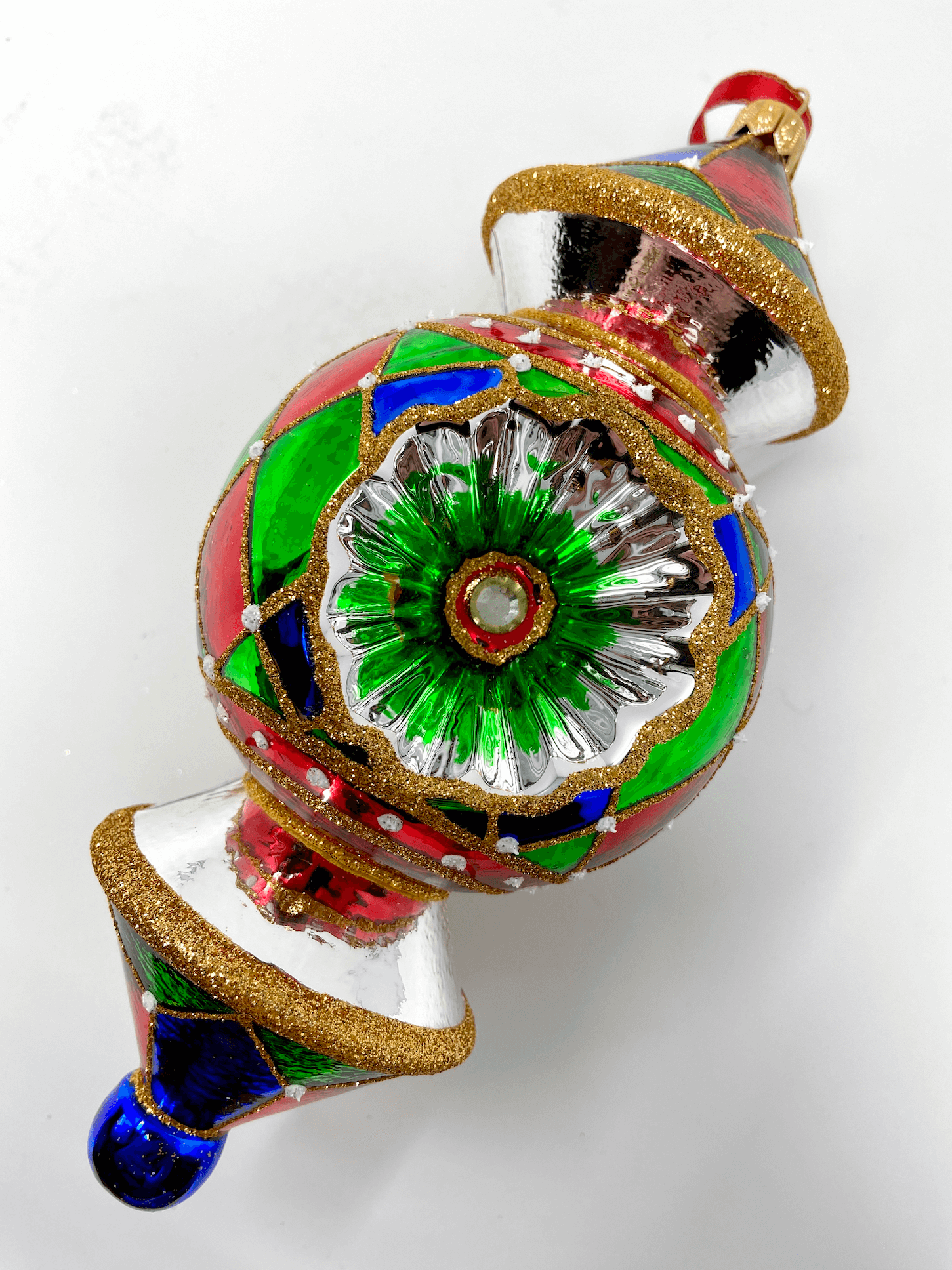 beautiful triple-barrel reflector glass ornament with colorful patterns and gold detailing. Polish glass christmas ornaments in saturated colors.
