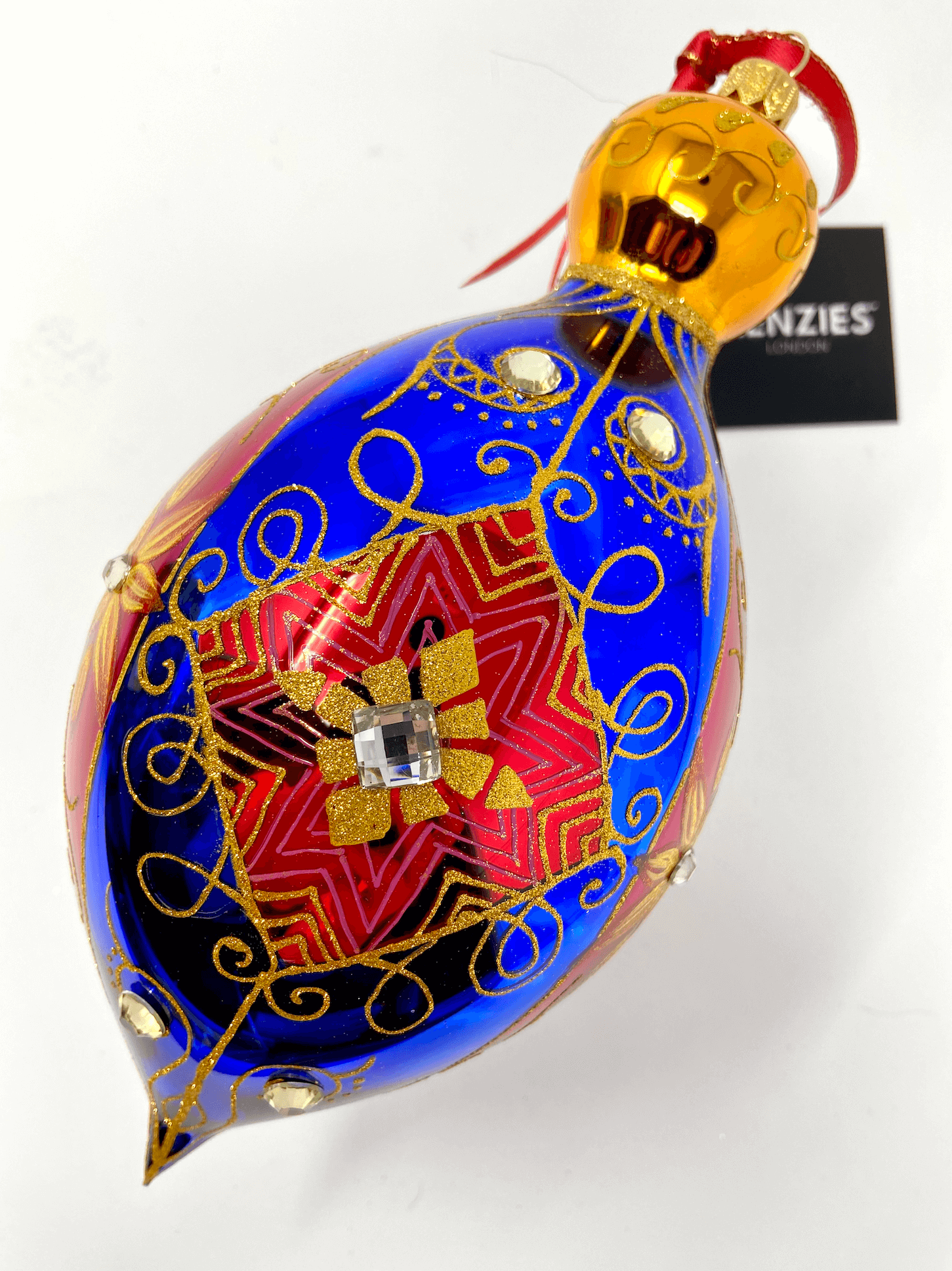 Generously oversized polish glass christmas ornament bauble decorated in blue and red stripes with gold damask detailing.