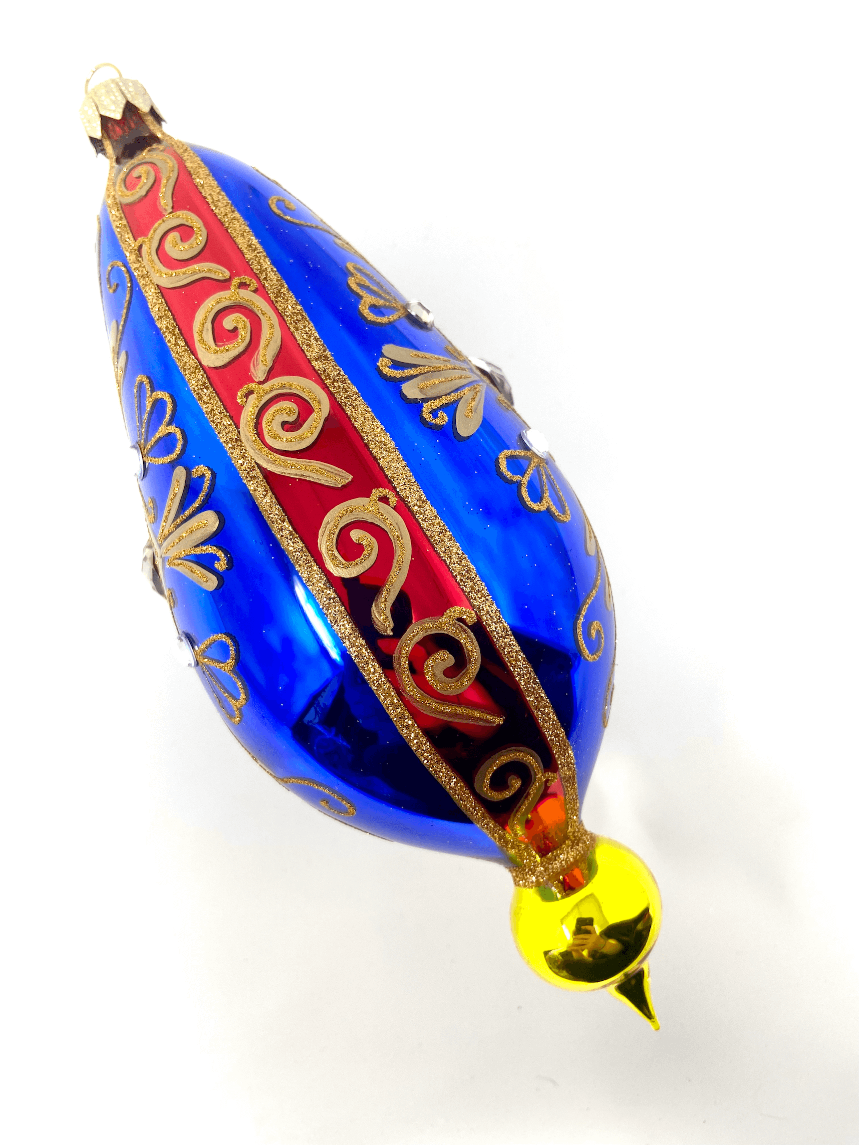 Blue eggplant shaped ornament featuring gemstones, intricate gold detailing, and hand painted floral blooms. A Christmas polish glass ornament. Floral Escape Floral Fetish.