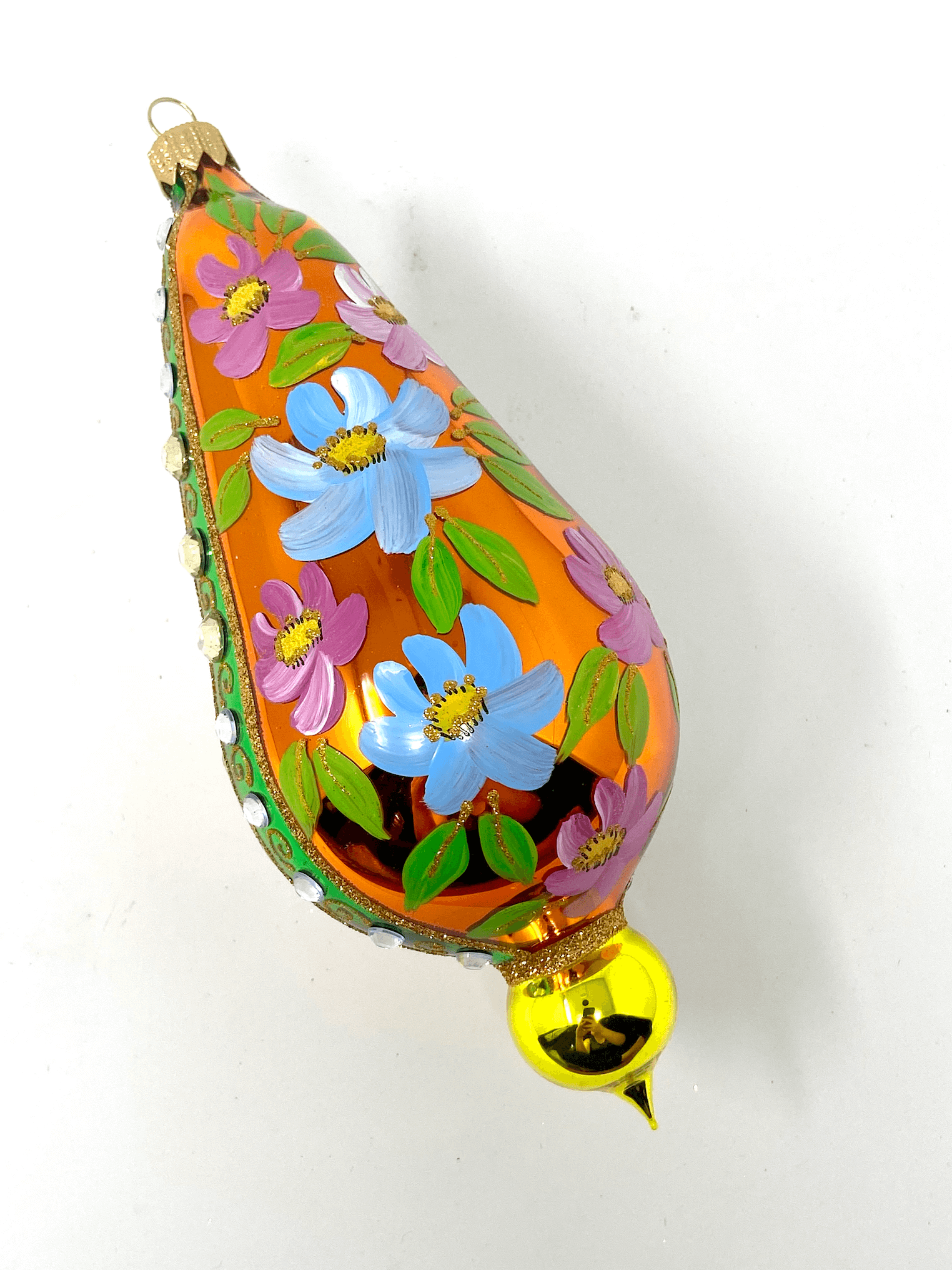 Orange eggplant shaped ornament featuring gemstones, intricate gold detailing, and hand painted floral blooms. A Christmas polish glass ornament. Floral Escape Floral Fetish.